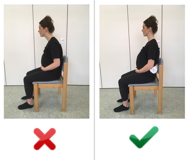 Woman shown sitting in chair incorrectly slumped forward then woman shown sitting with a rolled towel supporting her back