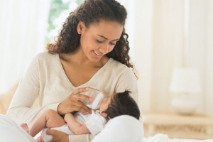 Mother bottle feeding newborn baby